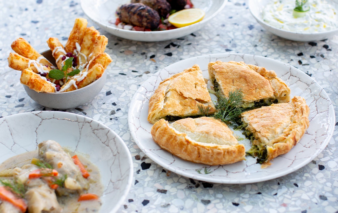 several plates of different greek food